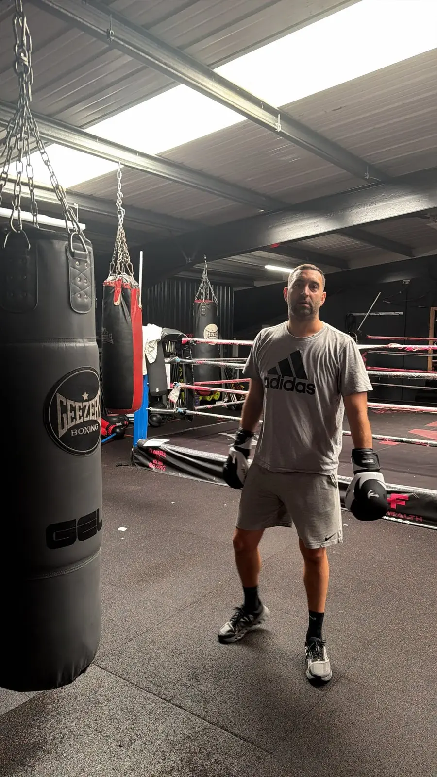 Richard in the gym beside a heavy bag after the session