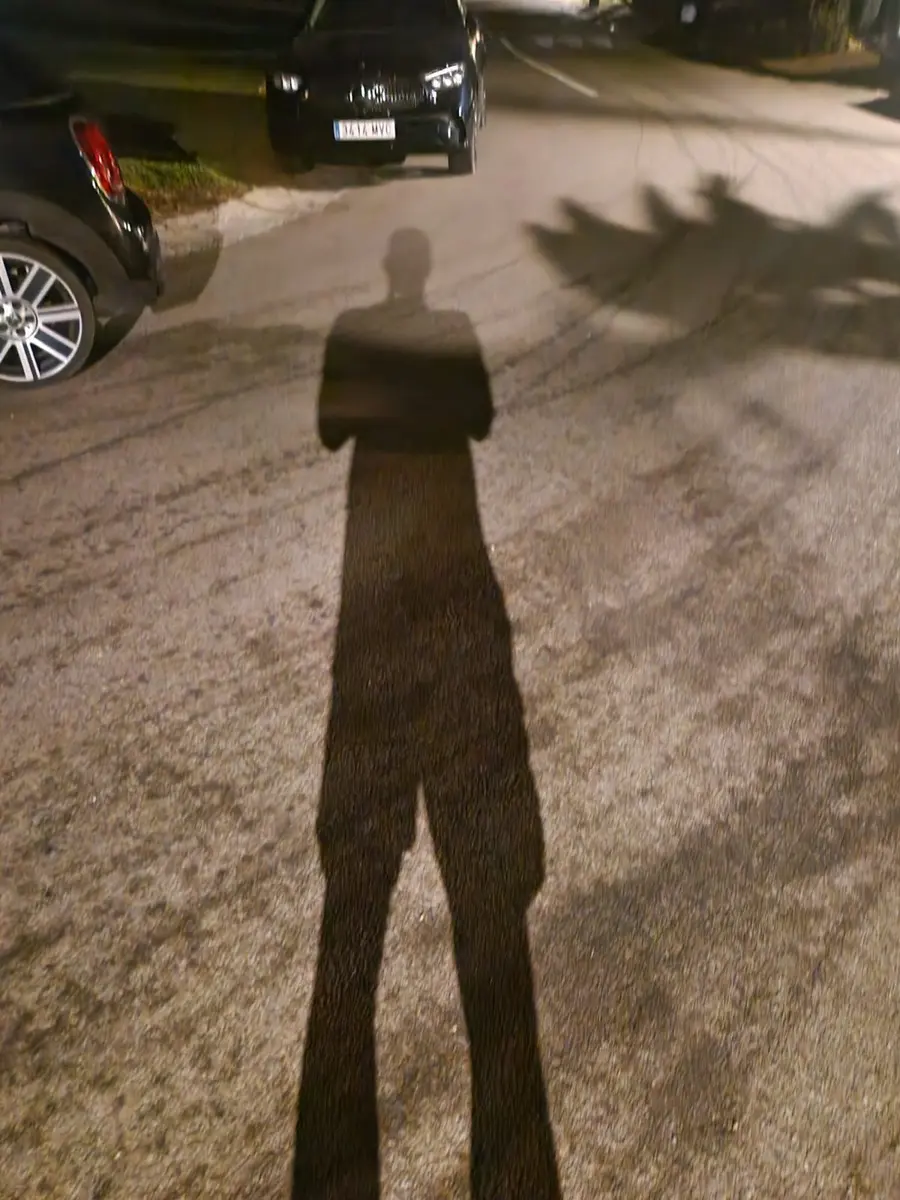 A shadow on a dark road during an early morning run