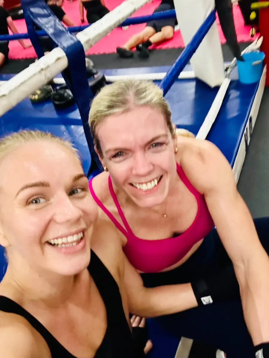 Becky and Rosa smiling together in the gym