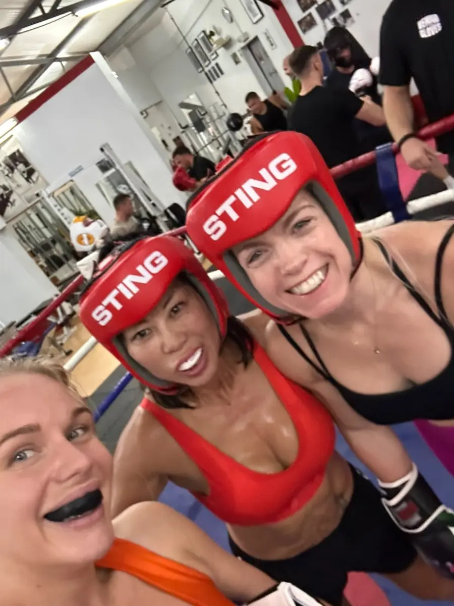 Two fighters in head guards after sparring in Lisbon