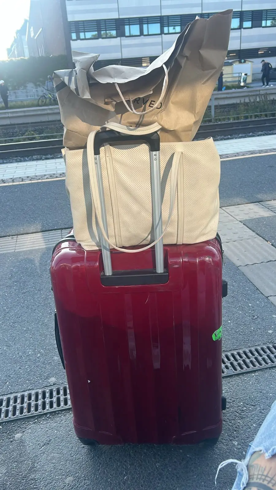 A suitcase and bags on a station platform