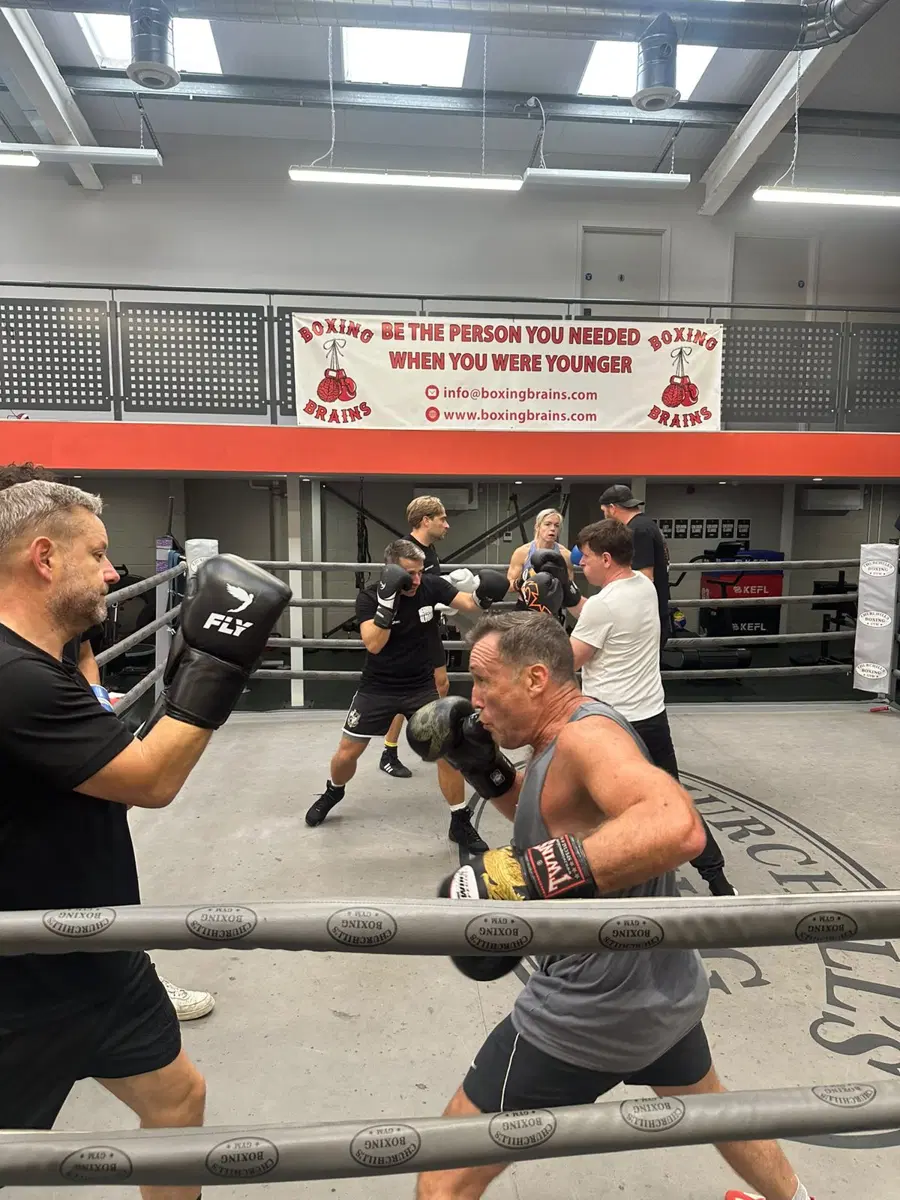 A fighter working the pads with a coach