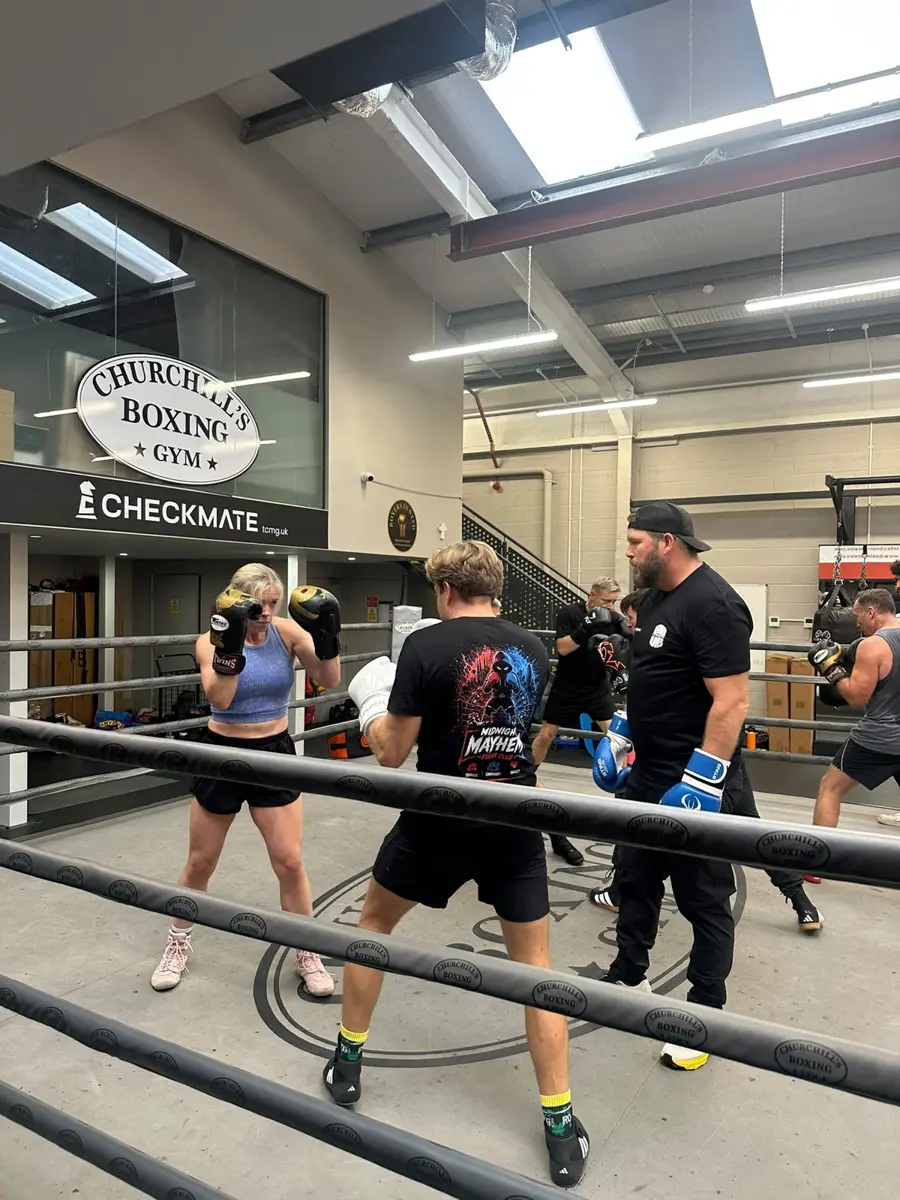 Coaches watching fighters work in the ring