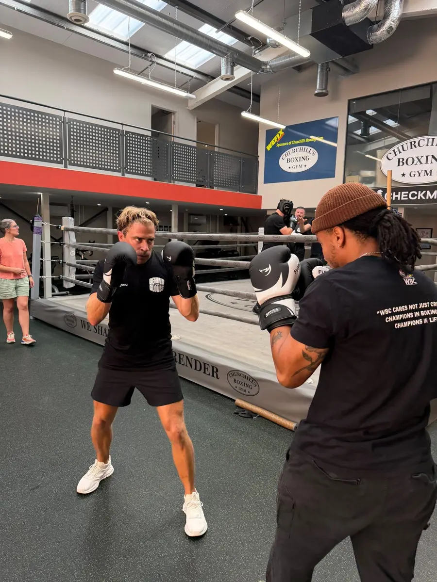 Pad work with a WBC Cares UK coach beside the ring