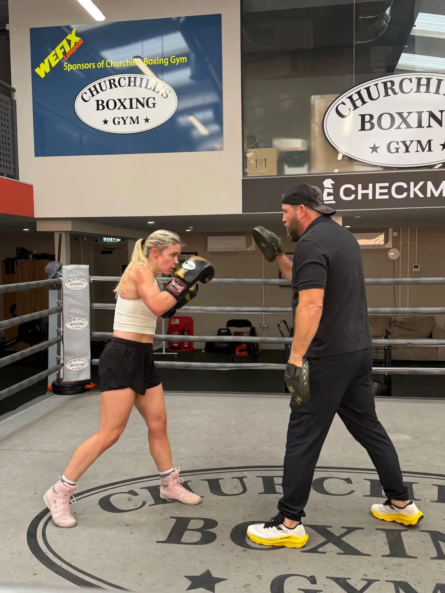 Combinations on the pads under the Churchill’s Boxing Gym sign